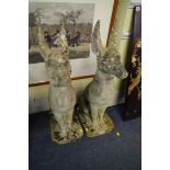 A pair of composition stone Egyptian dogs, 84cm high.