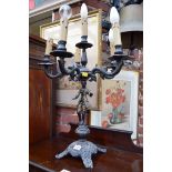 A painted metal figural six light candelabrum.