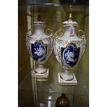 A pair of Continental porcelain twin handled vases and covers,