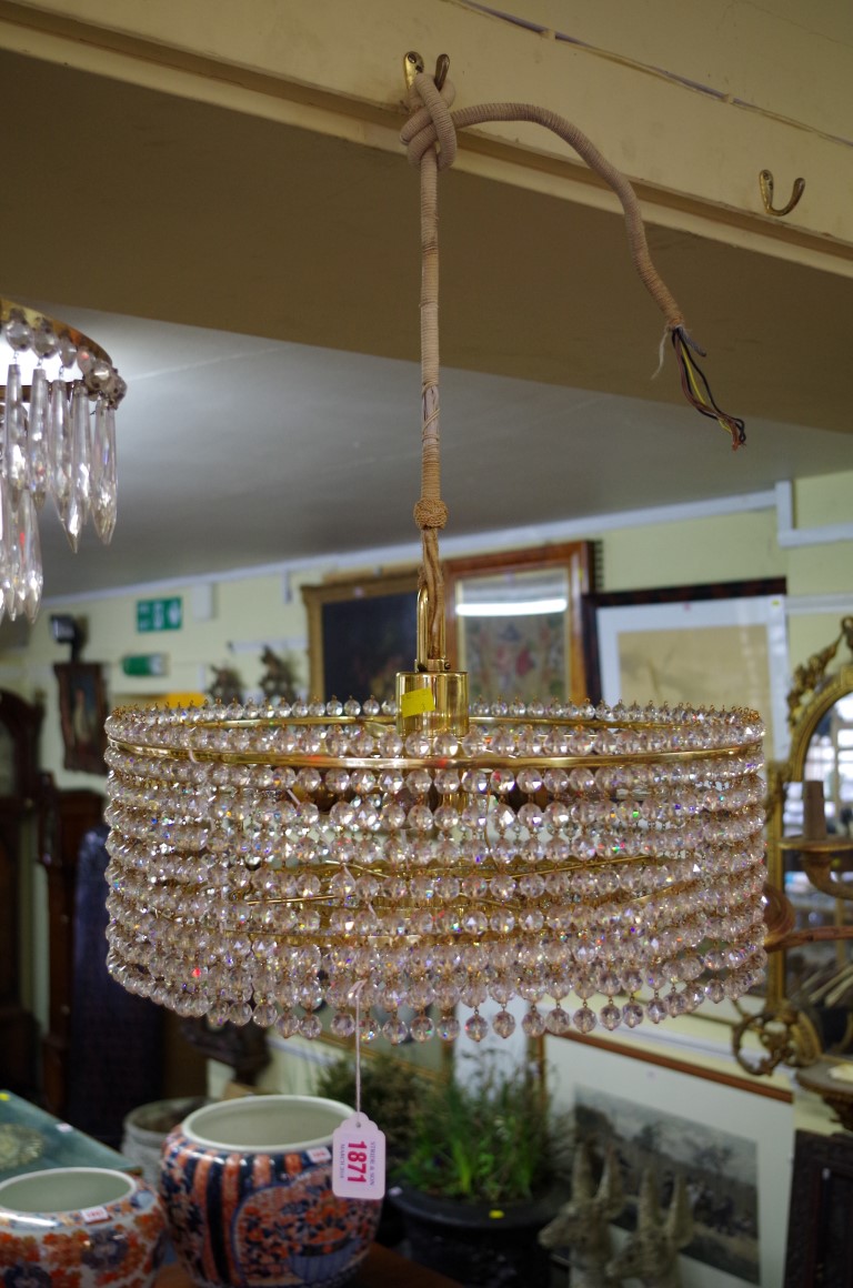 A vintage Lobmeyr brass eight bulb five tier chandelier; together with another four tier chandelier.