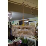 A vintage Lobmeyr brass eight bulb five tier chandelier; together with another four tier chandelier.