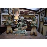 A set of three Thai verdigris and gilt metal figures, largest 39cm high.