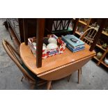 An Ercol drop leaf table, 108cm wide; together with a set of four Ercol dining chairs.