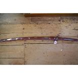 A Japanese katana and lacquered scabbard, with fullered damascus blade.