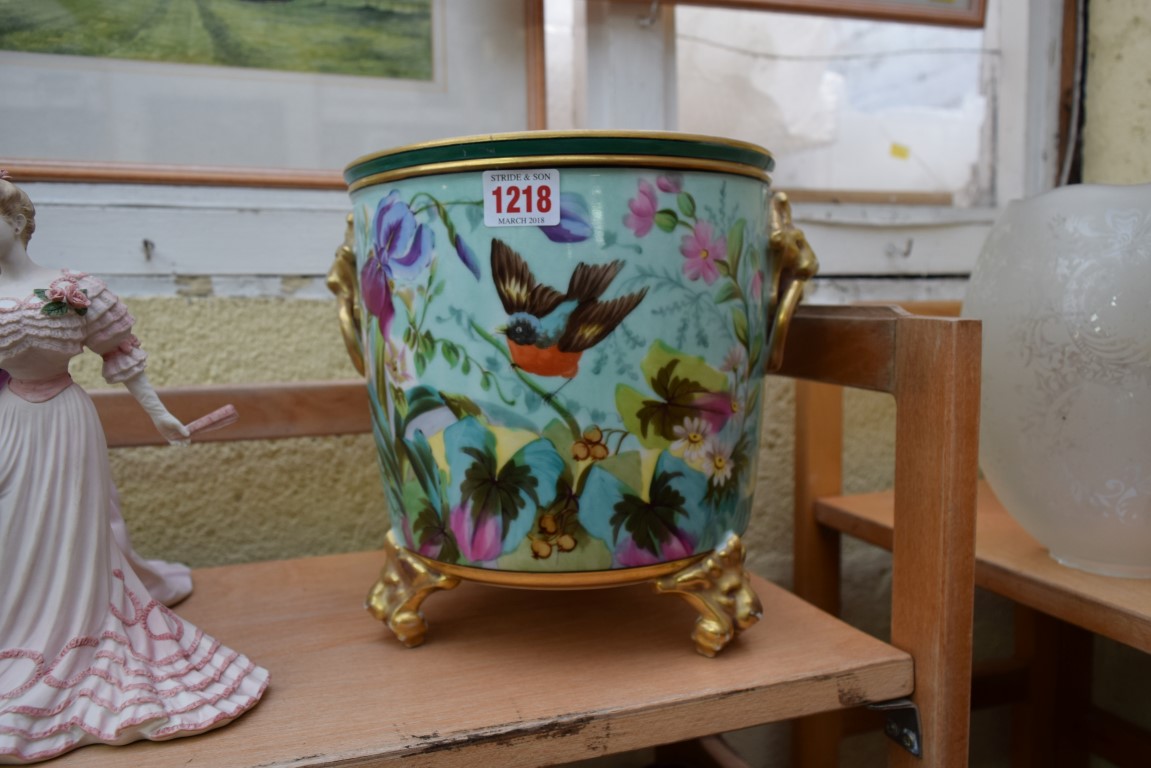 A Continental porcelain twin handled tripod jardiniere, 23cm high.