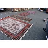 A large rug having repeated field; together with a Persian rug fragment,