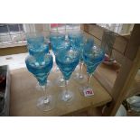 A set of eight blue glass and etched wine glasses, 14.5cm high, (chips).