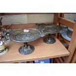 A pair of brass twin handled tazza, 22cm wide.