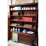 An antique mahogany open bookcase, with a pair of panelled cupboards below, 140.5cm wide.