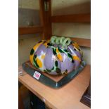 A novelty coloured glass pumpkin, 21cm diameter; together with another glass stand.