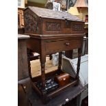 A carved oak bible box on stand, inscribed 'W.E.C.,1867', 58cm wide.