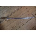 An 18th/19th century sabre sword, the burr wood pistol grip handle with brass mounts,