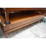 A vintage teak low occasional table, 150cm wide.