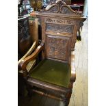 A circa 1900 carved oak wainscot style open armchair.