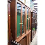 A near pair of old oak gun cabinets, with glazed doors, 67cm wide.