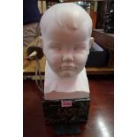 Ernest Roland Bevan, a white marble bust of a young boy's head, initialled, on green marble base,