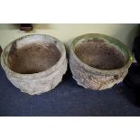 A pair of composition stone circular planters.