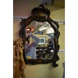 An antique Continental green painted and parcel gilt framed mirror, 70 x 45cm.