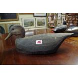 Two carved and painted wood decoy ducks, one labelled 'Lake Ontario, Prince Edward County'.