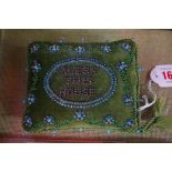 A Victorian beadwork 'Bless This House' pin cushion, 12cm wide.