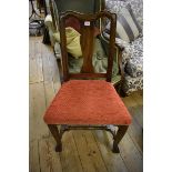 An antique walnut side chair.