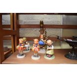 Five Hummel figures, to include a lamp.