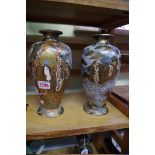 A pair of Japanese Satsuma pottery vases, 24cm high.