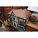 An old wooden beamed dolls house; together with associated furniture etc.