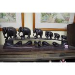 A carved ebony elephant train, of six graduating animals, 55cm wide.