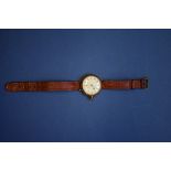 A 1920s gold gentleman's mechanical wristwatch, having 27mm white enamel dial,