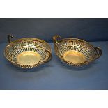 Two silver pierced baskets, by Fredricks Ltd, Birmingham 1907 & 1910, having swan neck handles,