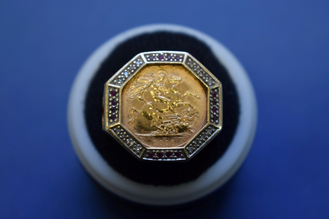 An Elizabeth II 2006 gold half sovereign, in a 9ct octagonal ring mount,