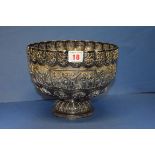 A Burmese white metal footed bowl, decorated native scenes and pierced rim, 20cm diameter.