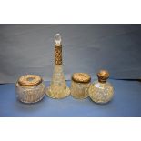 Four silver mounted cut glass dressing table bottles.