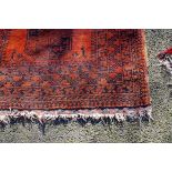 A Bokhara rug, having three central medallions on red ground, 135 x 105cm.