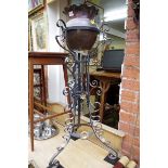 A circa 1900 wrought iron and copper jardiniere stand, 96cm high.