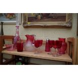 A collection of cranberry glass.