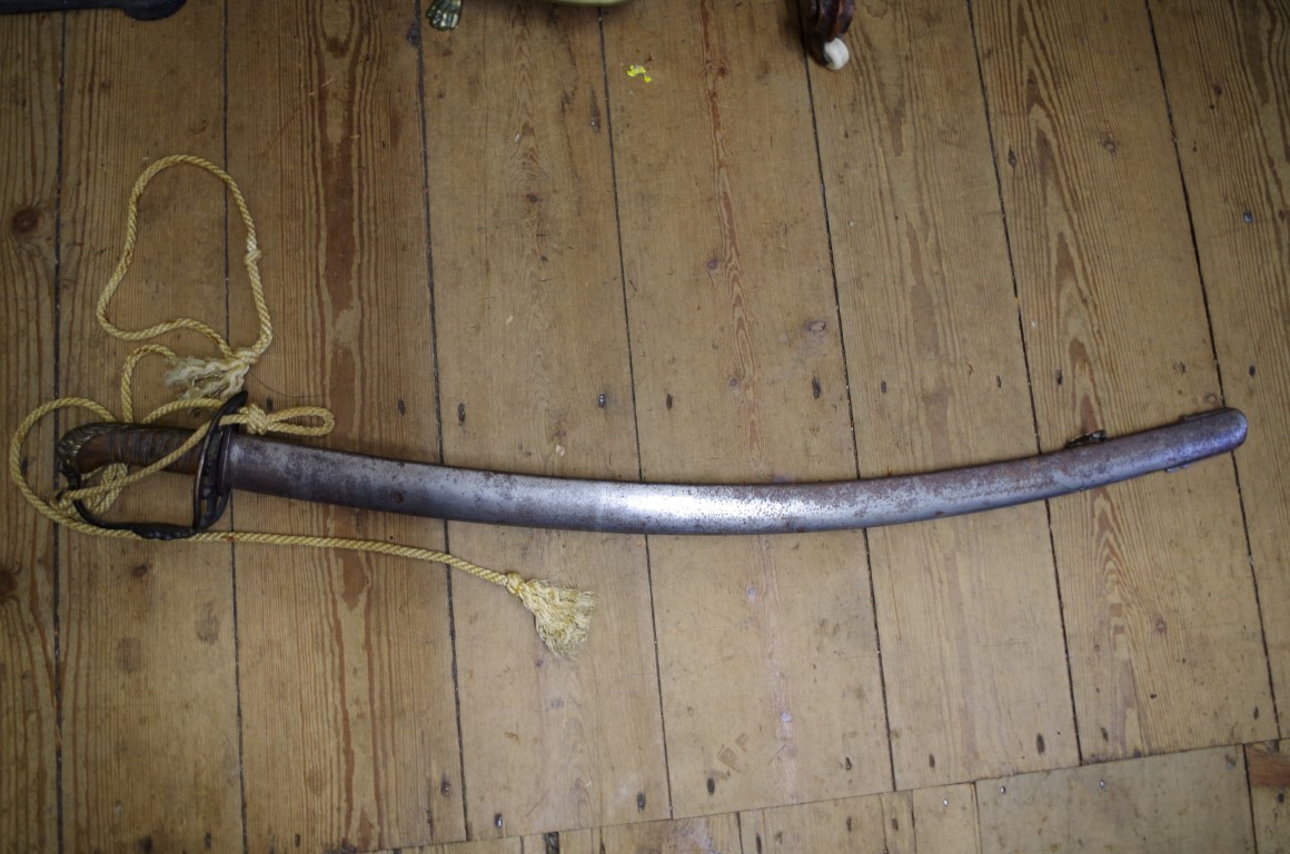 A 19th century cavalry sword and steel scabbard.