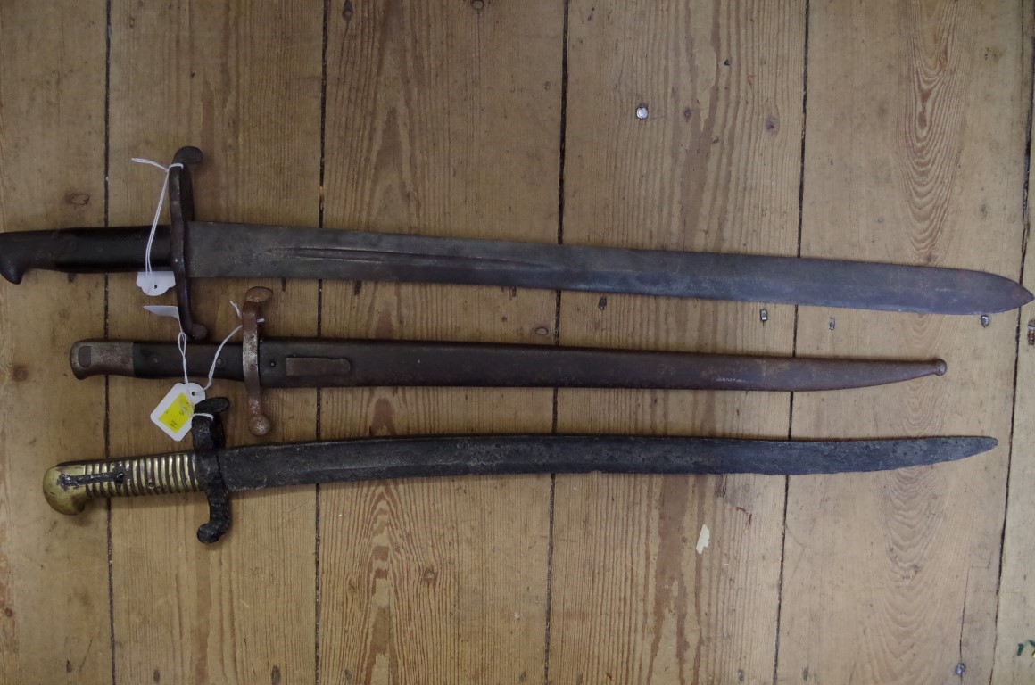 Three old bayonets, one with steel scabbard.