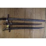 Three old bayonets, one with steel scabbard.