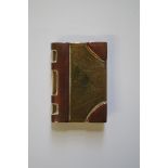 A World War I trench art novelty book form case, 5cm long.