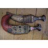 An eastern horn handled jambiya and metal mounted leather sheath; together with another similar