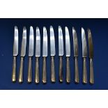 A set of eleven Victorian silver handled table knives, by John Biggins Ltd, Sheffield 1982; together