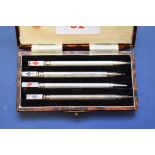 A cased set of sterling silver bridge pencils.