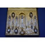 A cased set of Danish silver teaspoons, sugar tongs and cream ladle, having hammered bowls, one