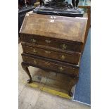 A reproduction Queen Anne style walnut and featherbanded bureau, 58.5cm wide.