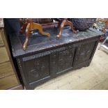 An antique carved oak coffer, 134cm wide, (alterations).