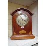 A late Edwardian mahogany and inlaid mantel wall clock, 38cm high.