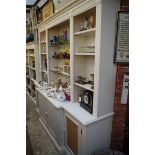 A contemporary white painted breakfront book case, 225cm wide.