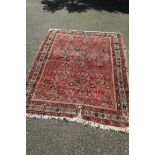A Persian rug, having allover floral design, 180 x 140cm.